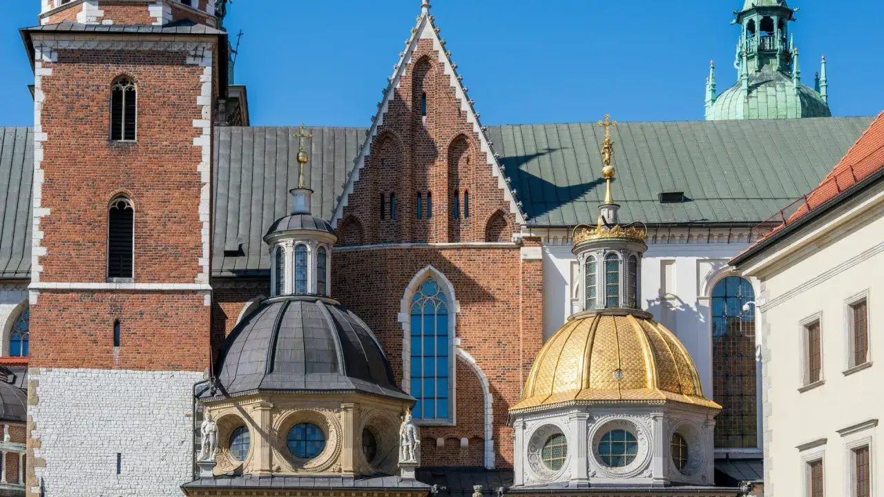 Krakowski Wawel, jeden z najpiękniejszych zamków w Małopolsce, z charakterystycznymi kopułami i ceglaną wieżą.